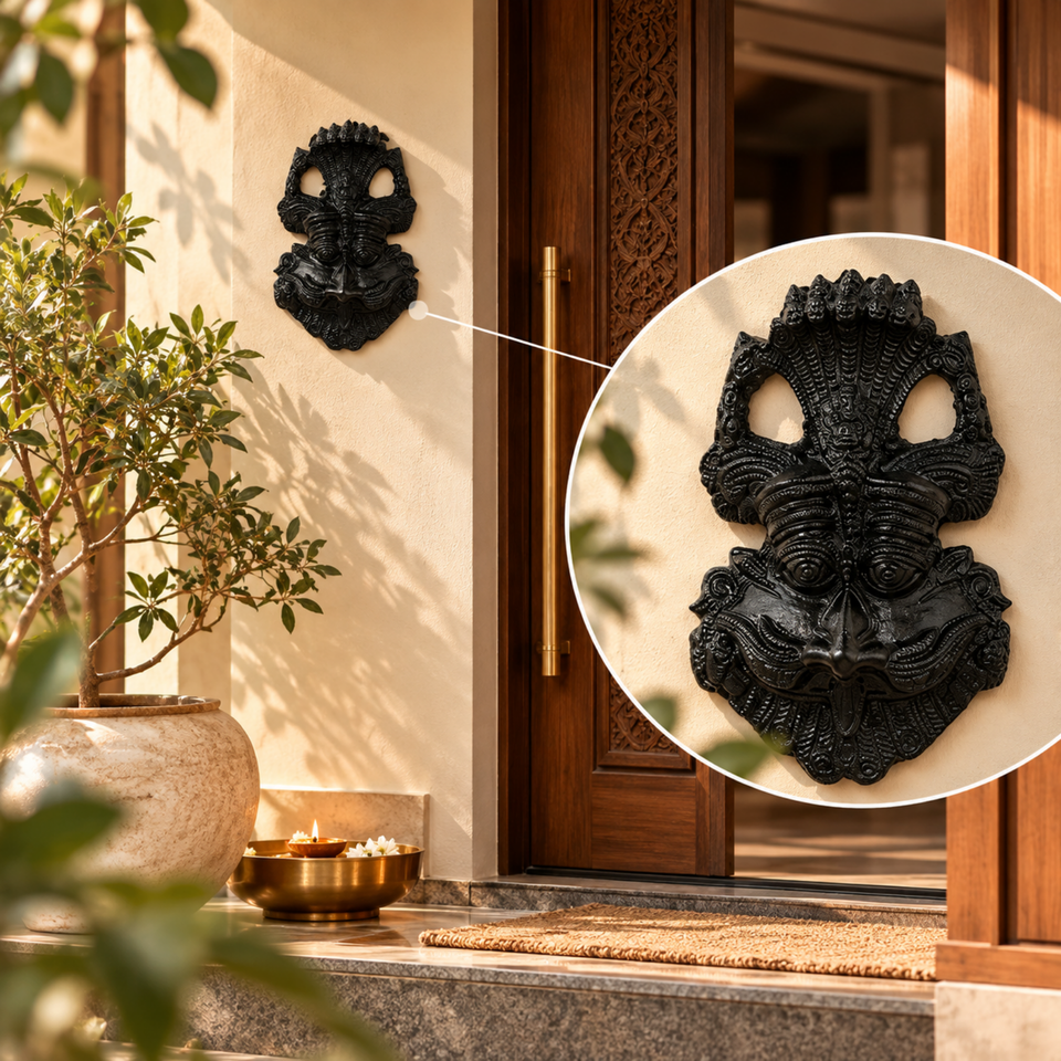 Black Kirtimukh wall hanging above a main door