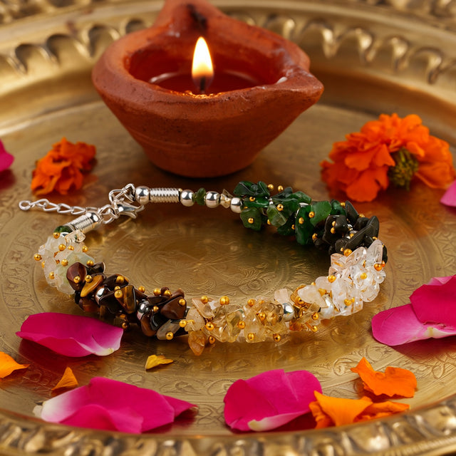 Women Dhan Yog Stone Bracelet on a brass tray with flower petals and a diya