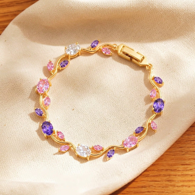 Pink and purple tulip bracelet resting on a dry cream cotton cloth
