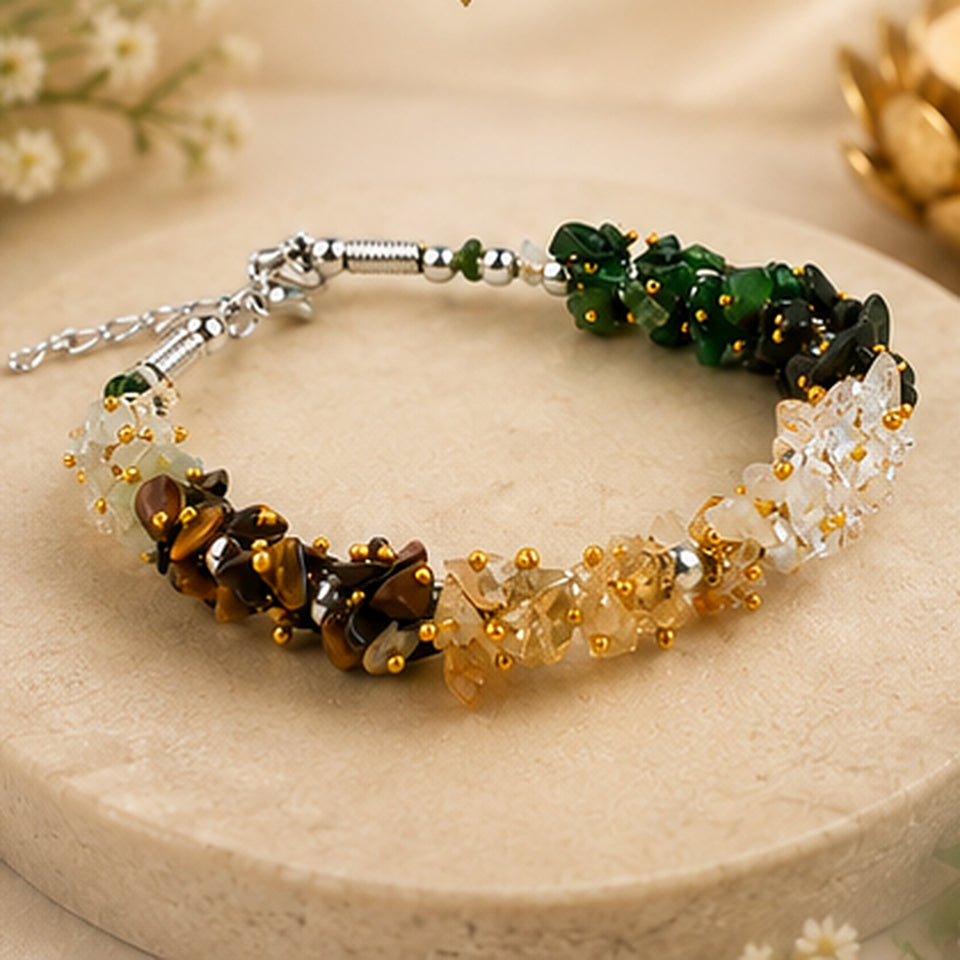 Dhan Yog gemstone chip bracelet with adjustable stainless steel chain on a stone plate