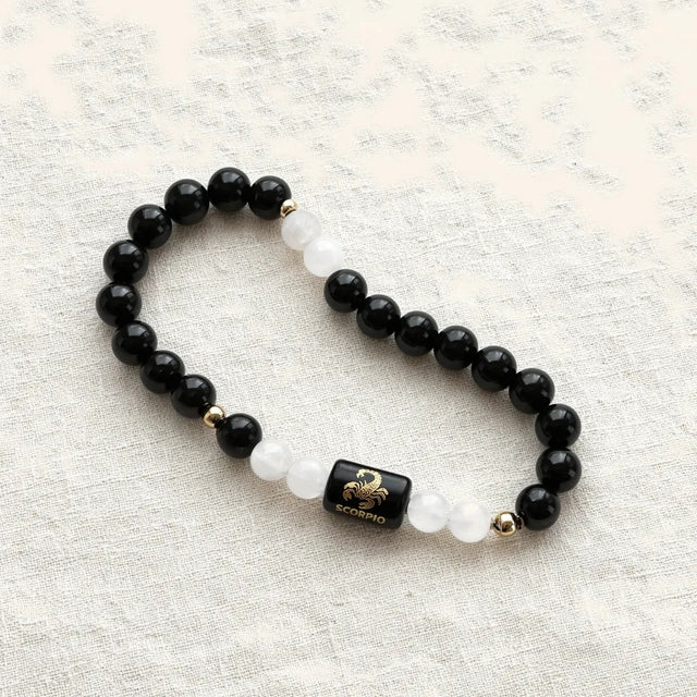 Scorpio zodiac bracelet laid on linen