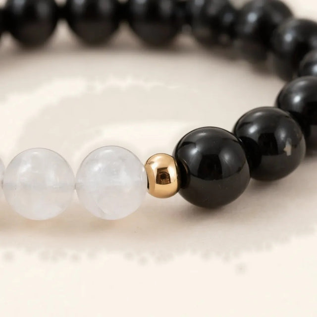 Close-up of black obsidian and milky quartz beads