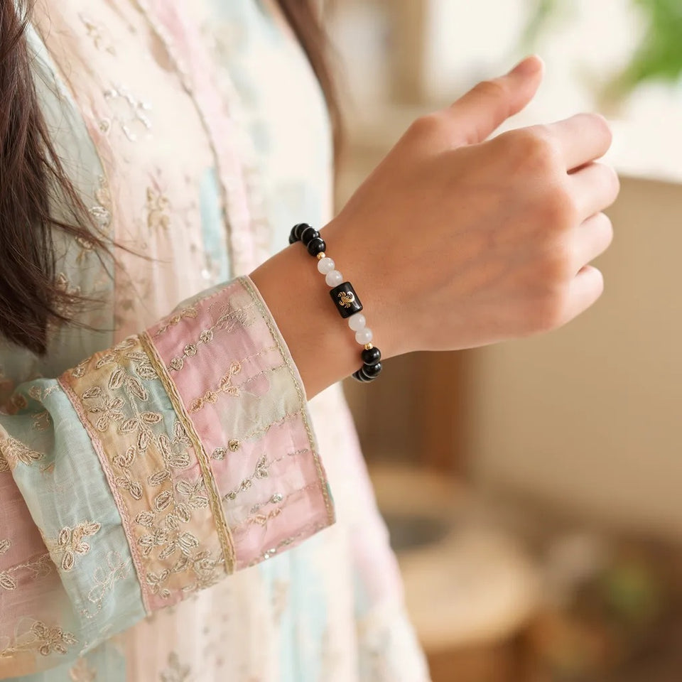 Scorpio zodiac bracelet on a woman's wrist with ethnic wear
