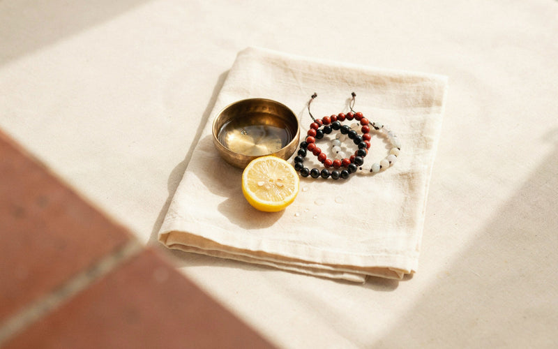 Three stone bead bracelets resting on a folded cream cotton towel