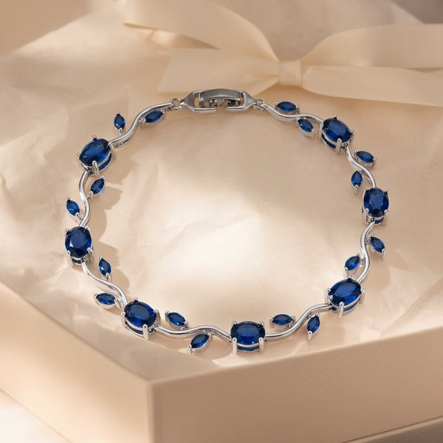 Blue tulip bracelet in a cream gift box with soft tissue paper and ribbon