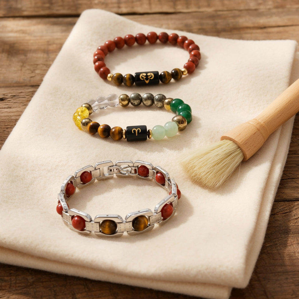 Three Aries bracelets on a cream cloth with a soft cleaning brush