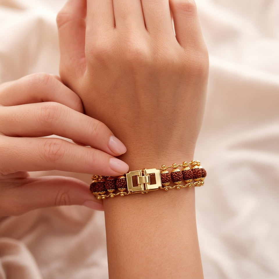 Gold plated 5 mukhi rudraksha bracelet clasp being fastened on a woman's wrist