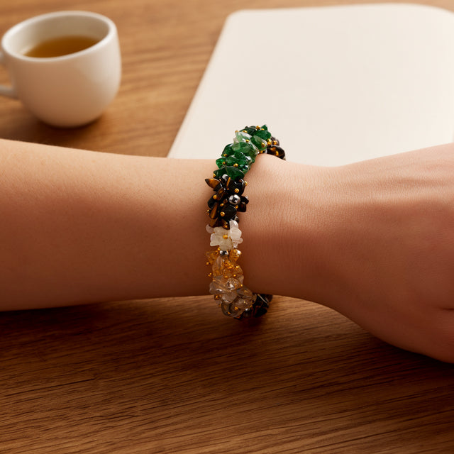 Women Dhan Yog Stone Bracelet worn at a desk with a cup of tea