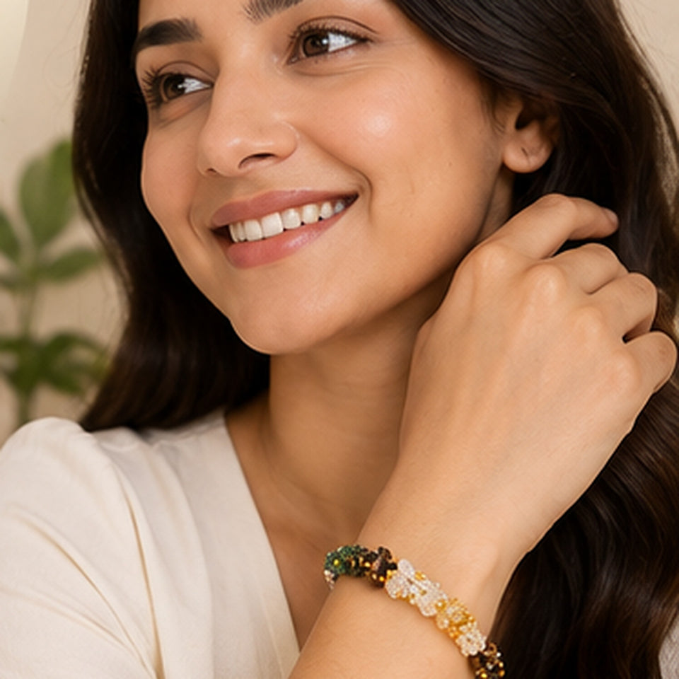 Smiling woman wearing the Dhan Yog gemstone chip bracelet