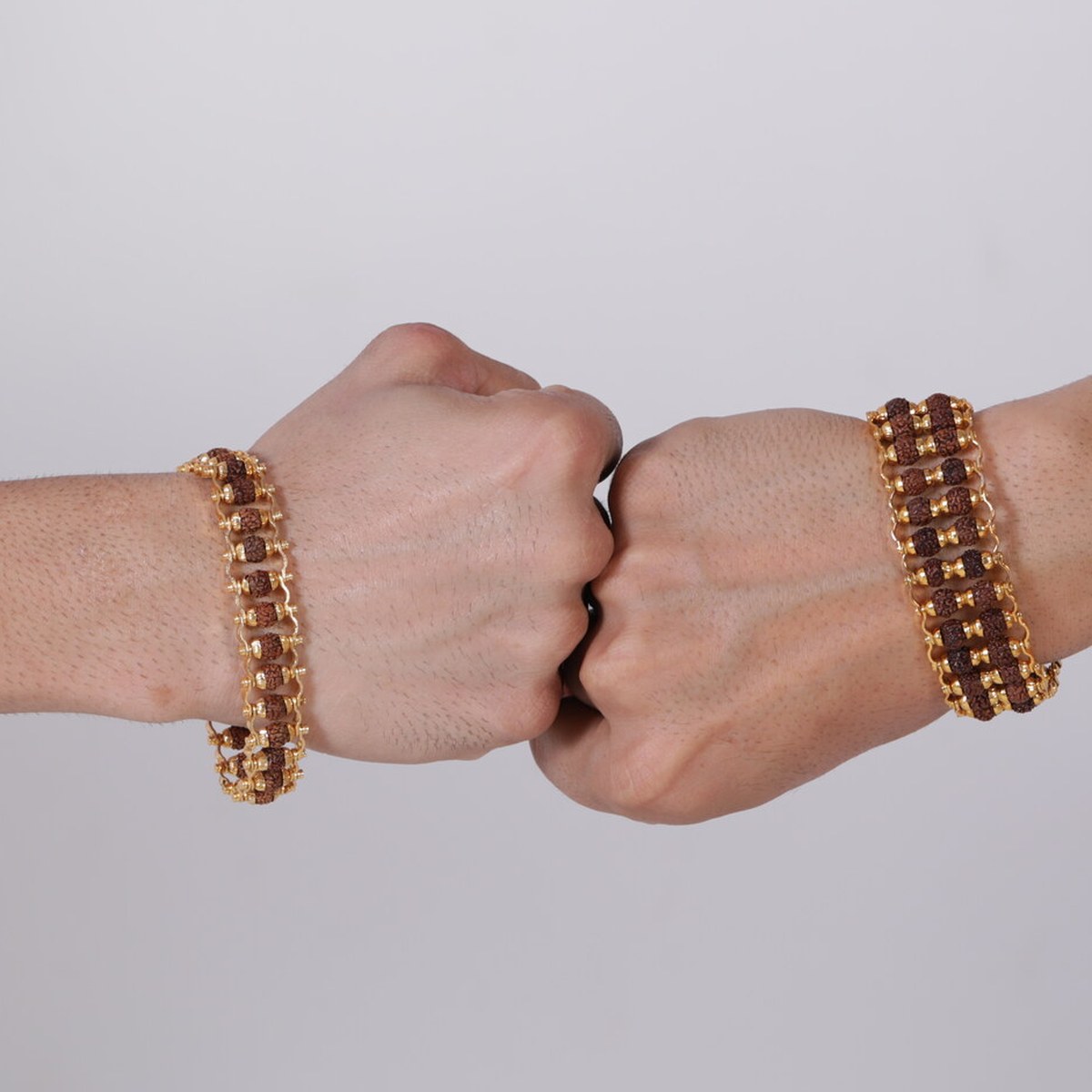 Two fists wearing rudraksha bracelets