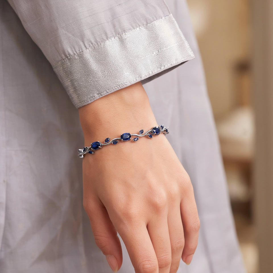 Blue tulip bracelet worn with a grey saree sleeve