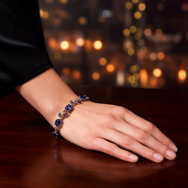 Blue tulip bracelet on a wrist resting on a table at an evening event