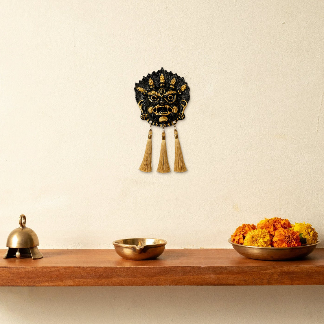 The hanging on the wall above a small puja shelf