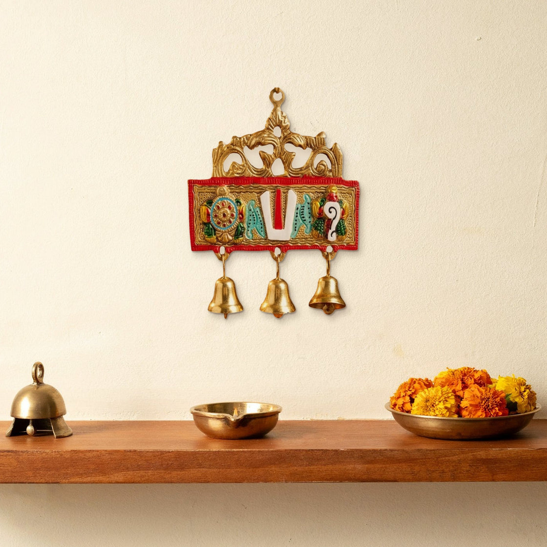 The hanging on the wall above a small puja shelf