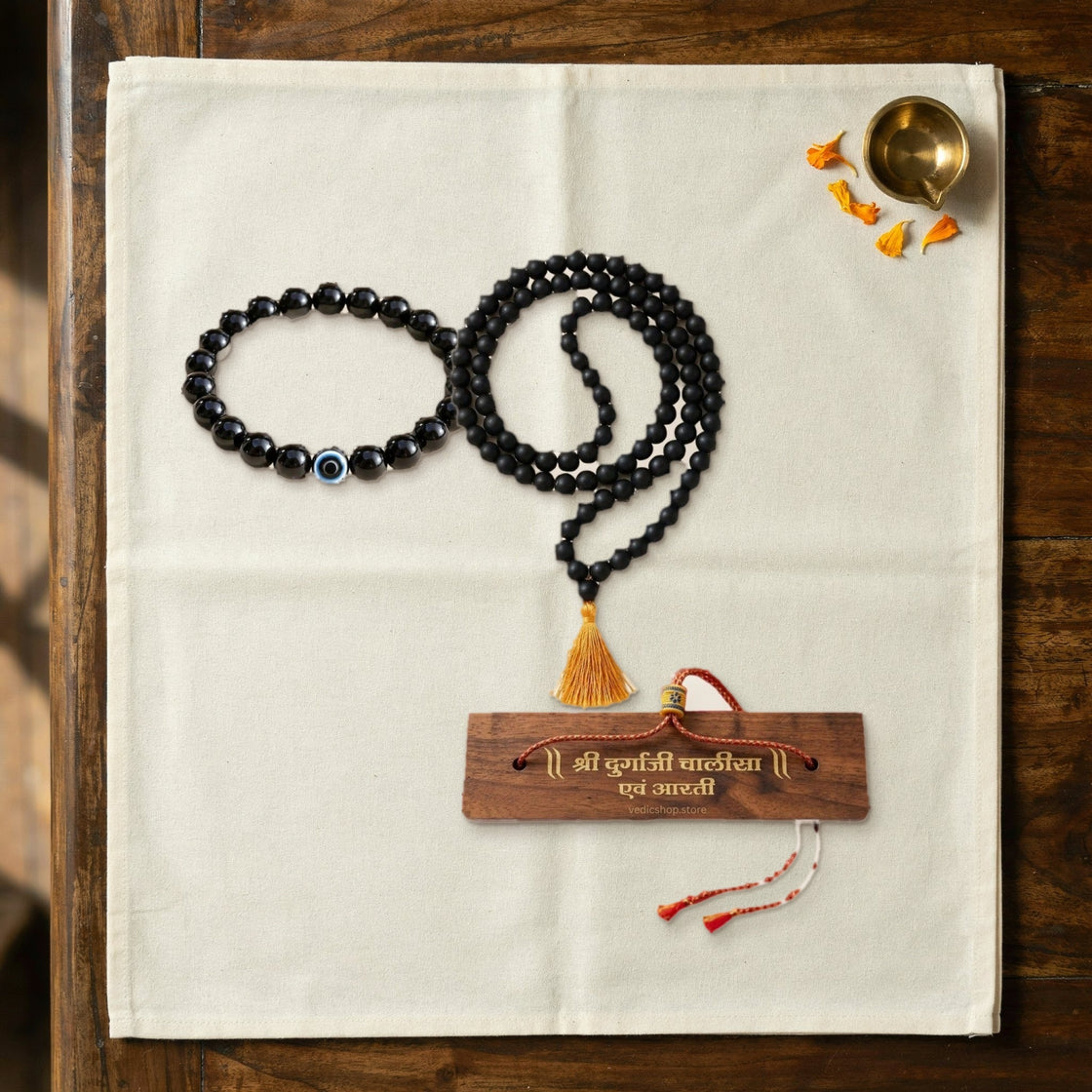 pieces of the nazar suraksha ritual laid out on a cream cloth