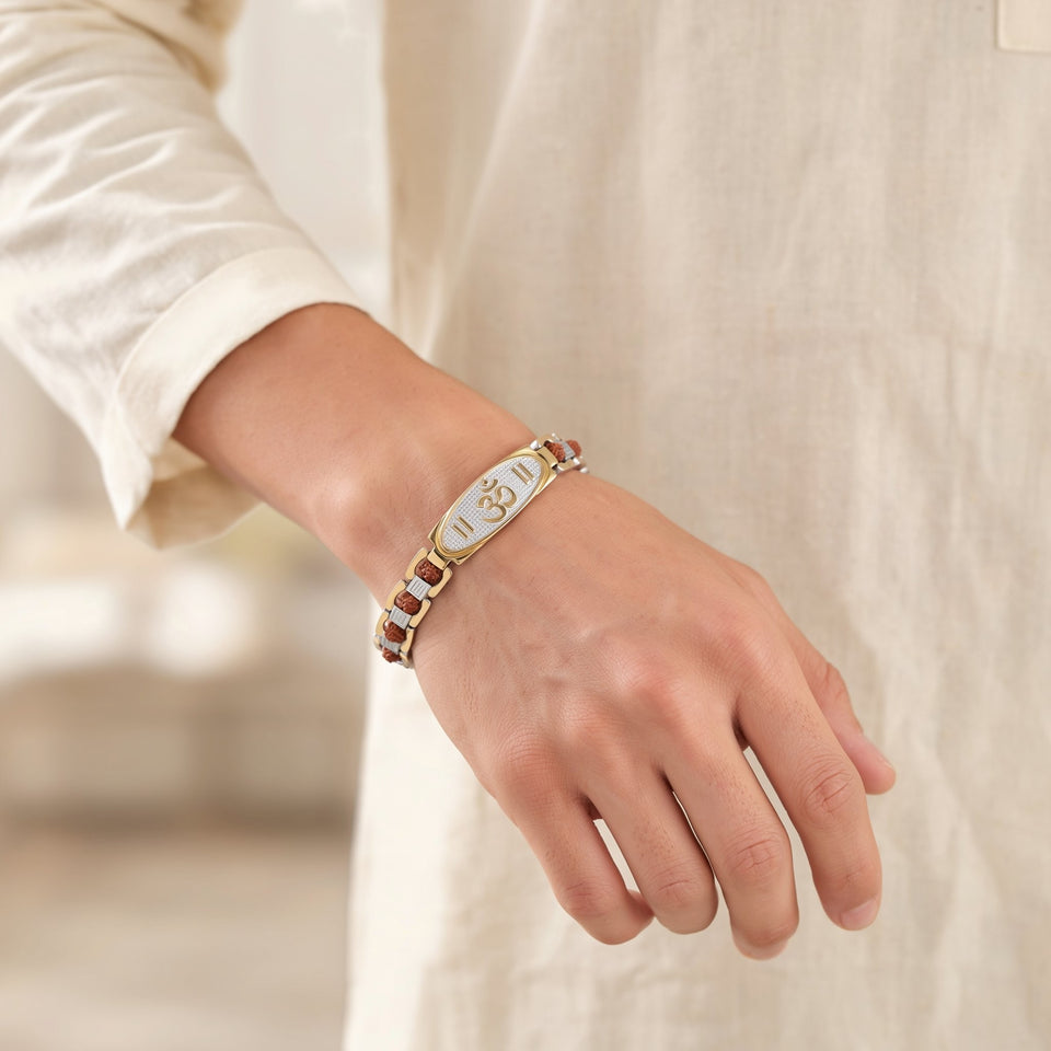 Man in a cream kurta wearing an Om rudraksha bracelet
