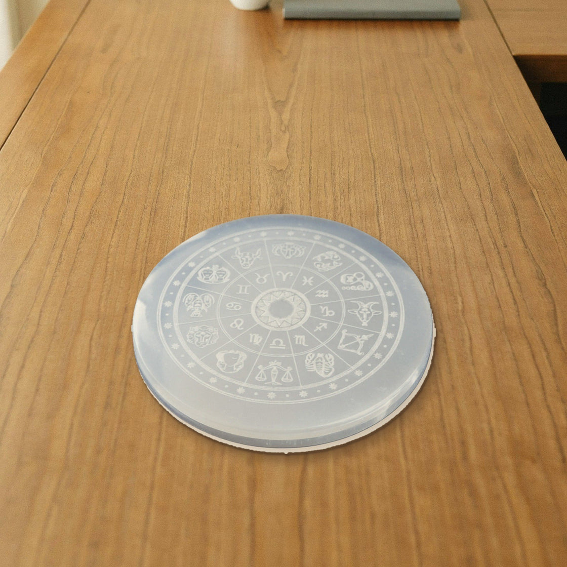 natural selenite charging plate placed on a wooden desk